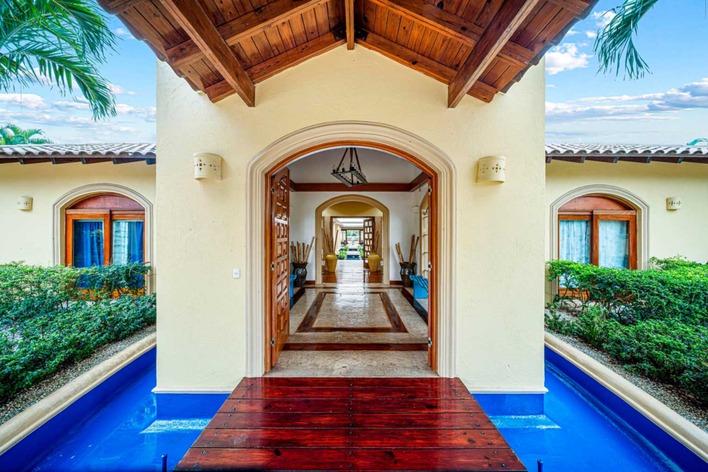 Villa entrance framed by water features
