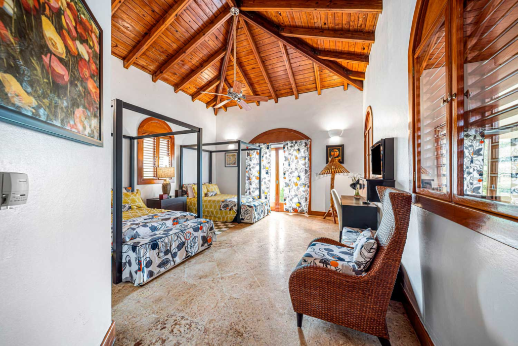 Bedroom with upholstered seating and timber ceiling