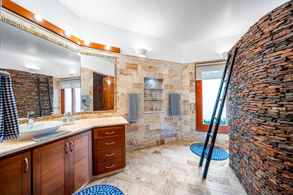 Bathroom vanity and stone shower area